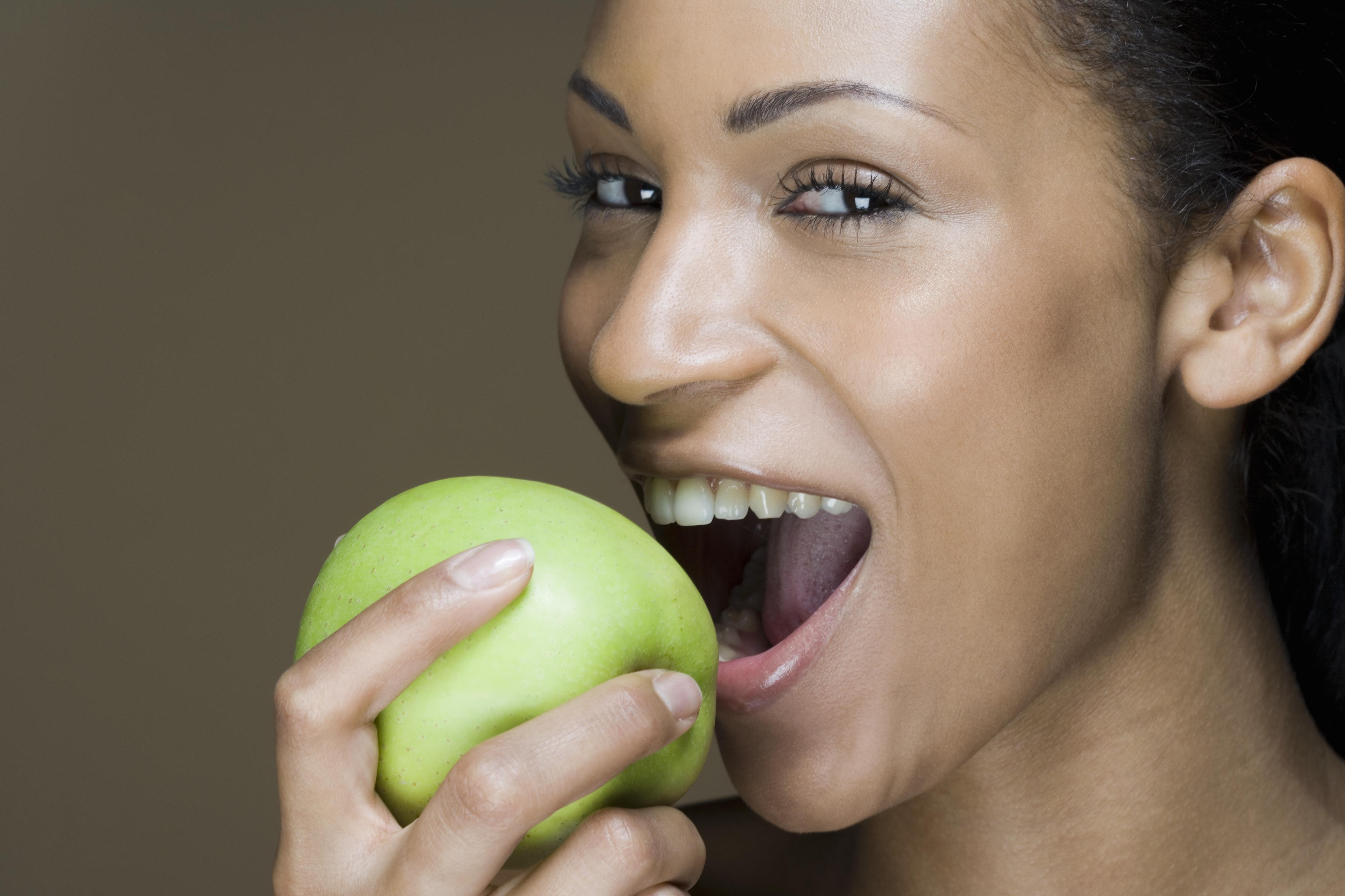A woman eating an apple