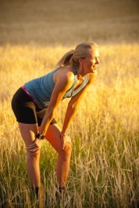 fit young woman resting after running