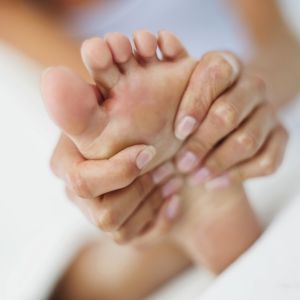 woman massaging her foot