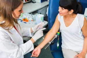 Drawing blood...young doctor prepairing for blood capture