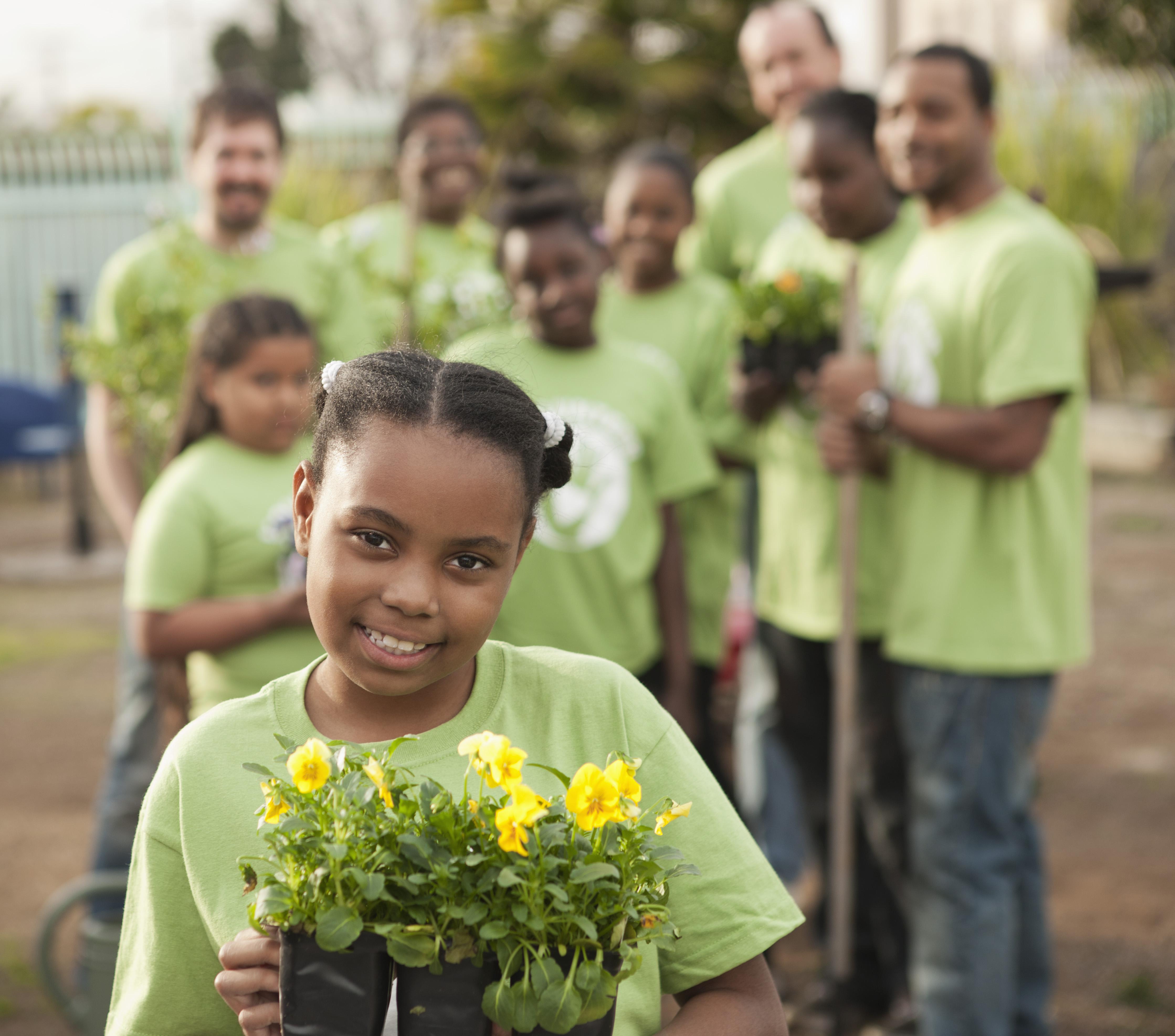Volunteers planting flowers in playground