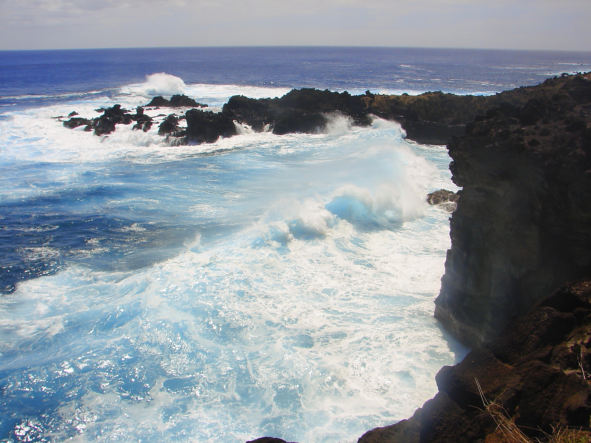 Impressive Easter Island and dramatic coastline shore: blue waves splashing on the rocks formation cliffs - Rapa Nui ancient civilization - Idyllic pacific ocean at dramatic sunset, dramatic landscape panorama – Chile