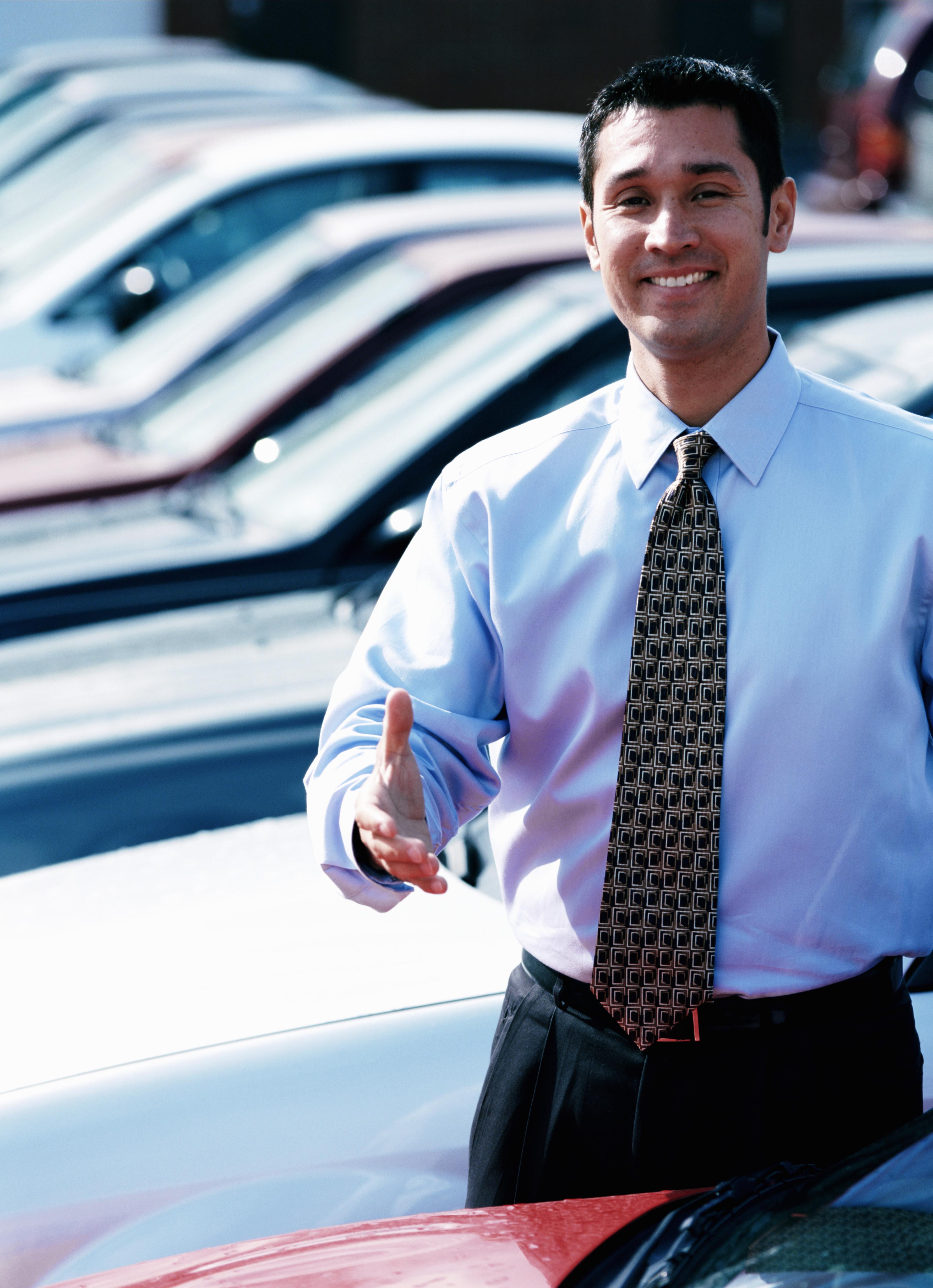 Car salesman in car lot