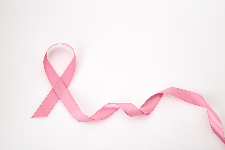 Close-Up Of Pink Ribbon Over White Background