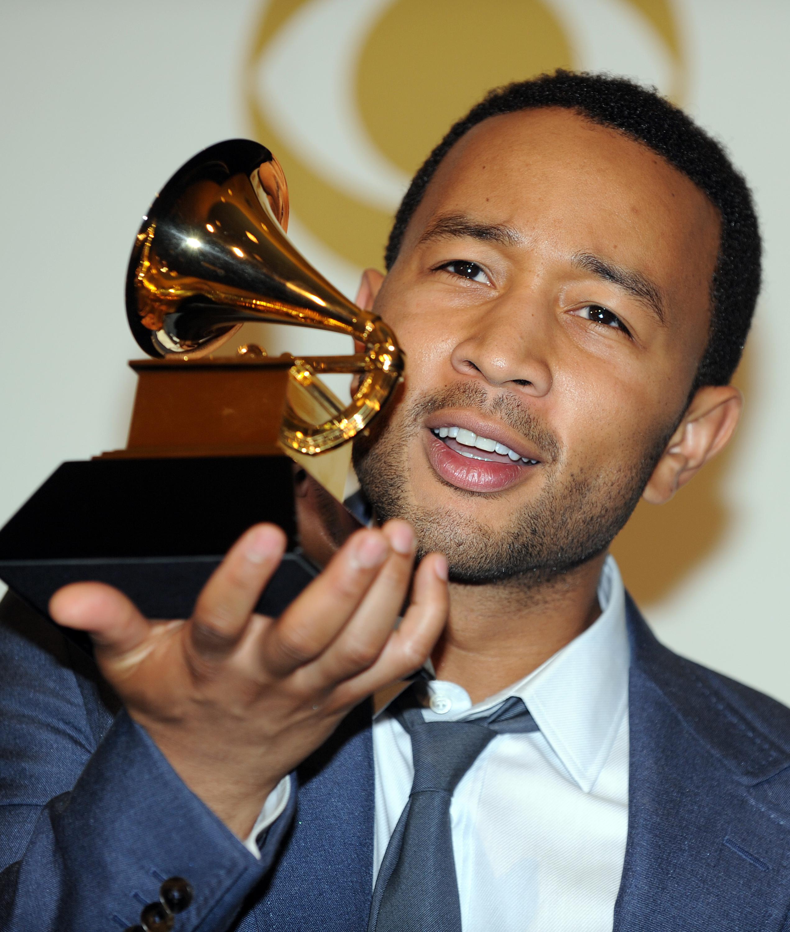 John Legend poses with his awards during