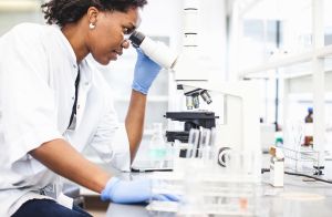 Scientist Looking into the Microscope