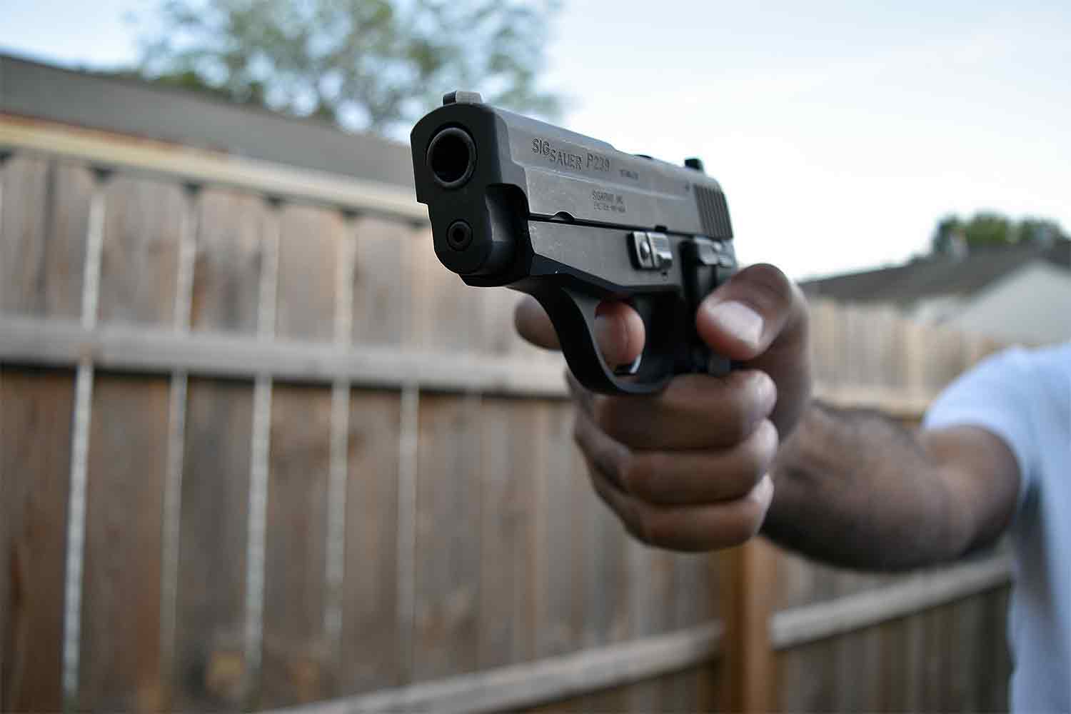Man holding handgun pistol