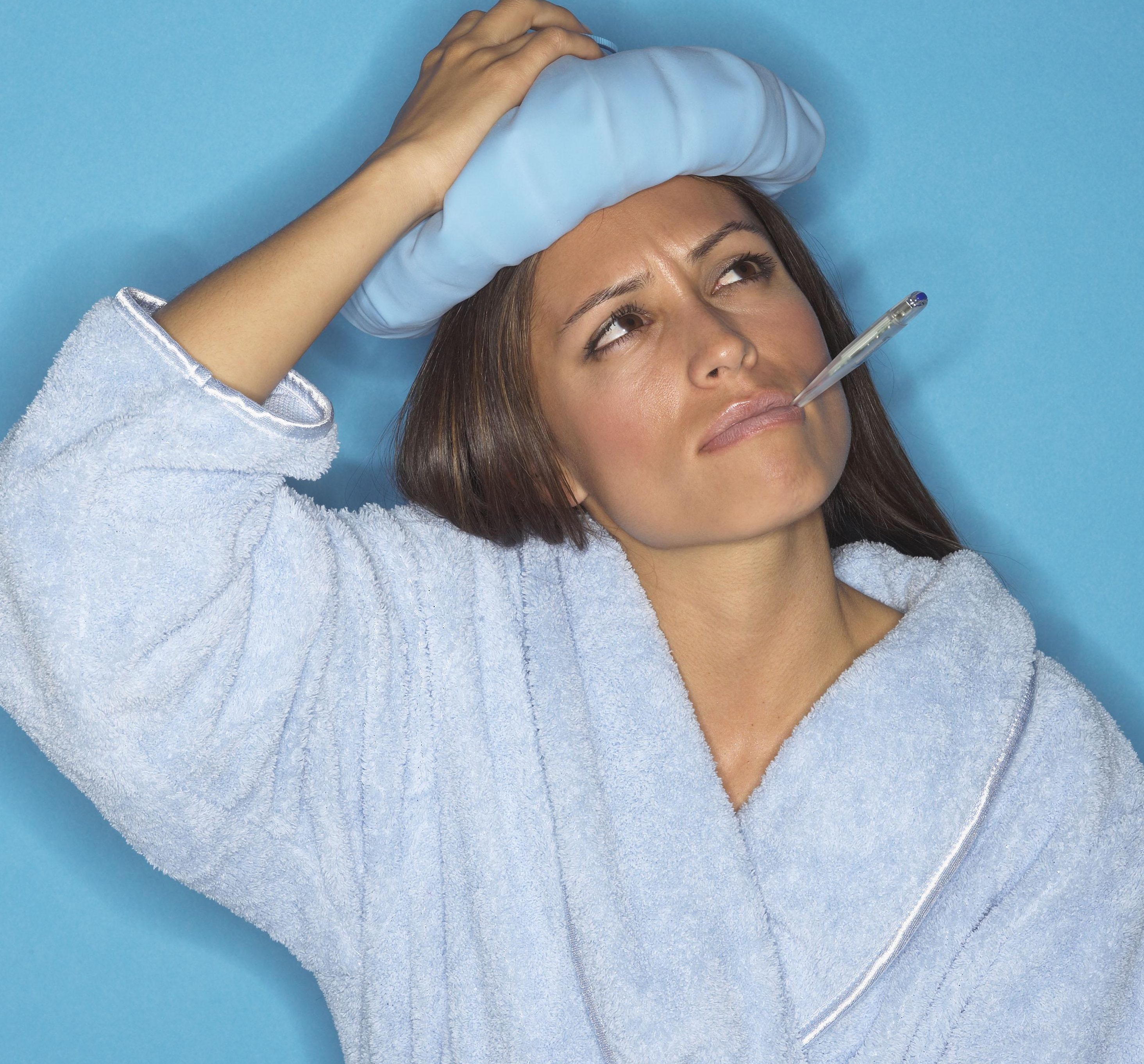 Woman with thermometer and icepack