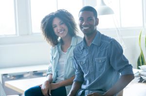 Business man and woman taking in an office.