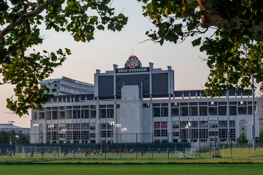 Students play soccer with the Ohio Stadium in the background...