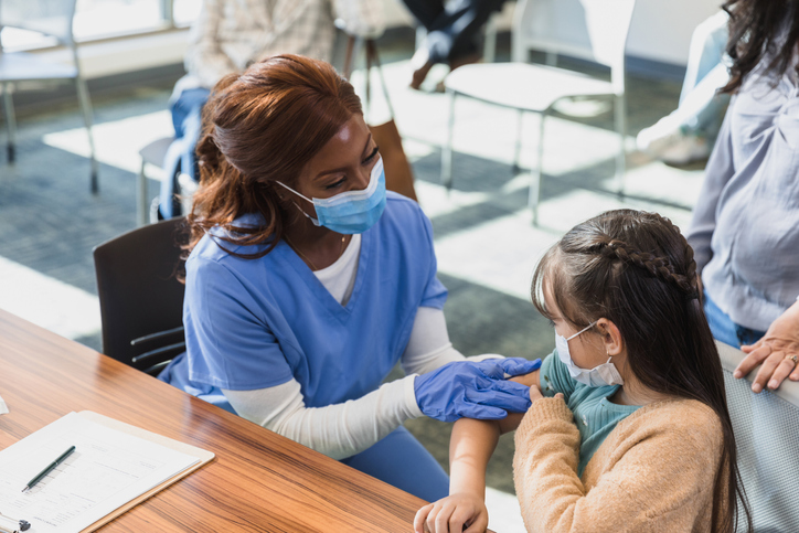 Nurse listens attentively to the young patient.